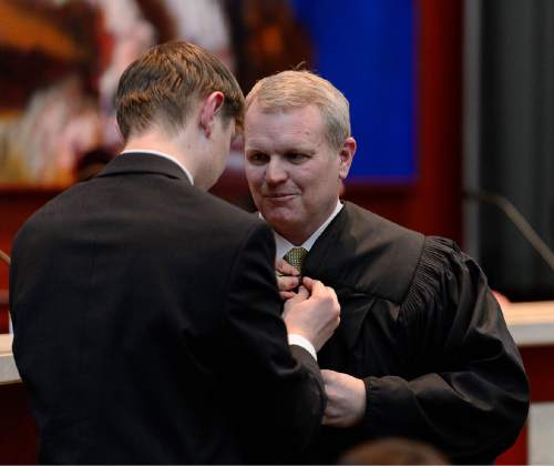 Trent Nelson  |  The Salt Lake Tribune
John A. Pearce, right, is robed by his son Ben Pearce at his Investiture Ceremony as a justice for the Utah Supreme Court, in Salt Lake City, Friday January 29, 2016.