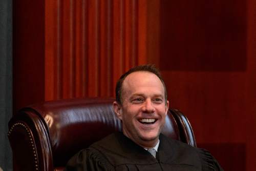 Trent Nelson  |  The Salt Lake Tribune
Justice Thomas Lee laughs as John A. Pearce speaks at his Investiture Ceremony as a justice for the Utah Supreme Court, in Salt Lake City, Friday January 29, 2016.