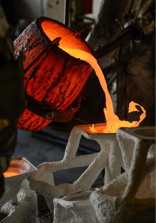 Francisco Kjolseth | The Salt Lake Tribune
Art flows and blooms through molten bronze as noted sculptor Gary Lee Price's staff pour pieces for a life-size  bronze sculpture in his Springville studio. The piece will be part of Price's Great Contributors exhibit of eight life-size bronze statues at this year's Dallas Blooms 2016 at the Dallas Arboretum and Botanical Garden. The statues (Mark Twain, Abraham Lincoln, Benjamin Franklin, George Washington, Claude Monet, Albert Einstein, William Shakespeare and the Wright Brothers) will be seated throughout the 66-acre garden, with about 500,000 blooms from spring bulbs, from Feb. 27 to April 10.