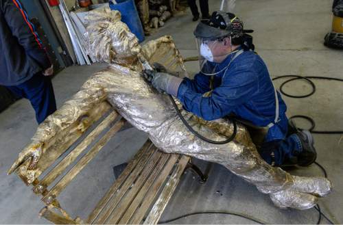Francisco Kjolseth | The Salt Lake Tribune
Einstein gets touched up as Humberto Morales grinds away a weld on a sculpture created by Gary Lee Price at his Springville studio. The piece will be part of Price's Great Contributors exhibit of eight life-size bronze statues at this year's Dallas Blooms 2016 at the Dallas Arboretum and Botanical Garden.