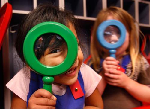 Scott Sommerdorf   |  The Salt Lake Tribune
Rosa Duarte, 4, left, and Viola Corley, 4, investigate small plastic bugs and leaves with magnifying glasses in Mrs Shackelford and Mrs. McDonald's pre-school classroom #206 at Wright Elementary School, Thursday, October 24, 2013. County mayor Ben McAdams, Republican and Democratic councilmen and school district officials visited the classroom filled with kids who were able to get in because of an appropriation that allowed 600 more kids to get into Granite School District preschools this fall.