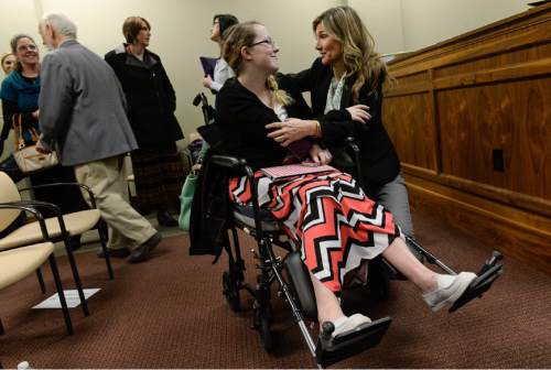Francisco Kjolseth | The Salt Lake Tribune
Jackie Dillard, 28, of Ogden who has had 37 surgeries due to Ehlers Danlos Syndrome and Osteonecrosis, celebrates a small victory with Christine Stenquist who has a brain tumor, after the medical marijuana bill, SB73, passed out of committee on Thursday night.