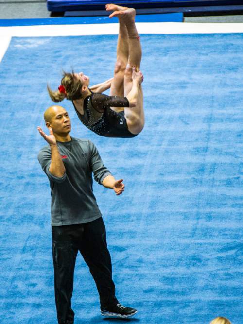 Chris Detrick  |  The Salt Lake Tribune
Co-Head Coach Tom Farden helps Utah gymnast Sabrina Schwab performs her floor routine during the Red Rocks Preview at the Huntsman Center Friday December 11, 2015.