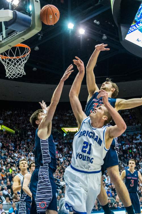 Chris Detrick  |  The Salt Lake Tribune
Brigham Young Cougars forward Kyle Davis (21) St. Mary's Gaels forward Dane Pineau (22) and St. Mary's Gaels forward Kyle Clark (33) go for a rebound during the game at the Marriott Center Thursday February 4, 2016. Brigham Young Cougars defeated St. Mary's Gaels 70-59.