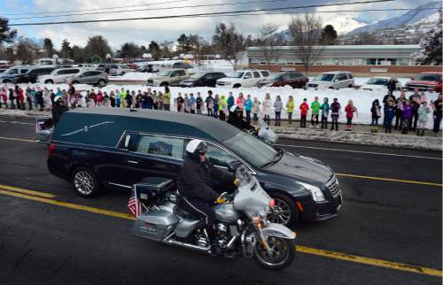 Scott Sommerdorf   |  The Salt Lake Tribune
Cottonwood Elementary shows it's respect for Officer Douglas Scott Barney, as about 400 of their students lined Holladay Boulevard along the funeral procession route, Monday, January 25, 2016.