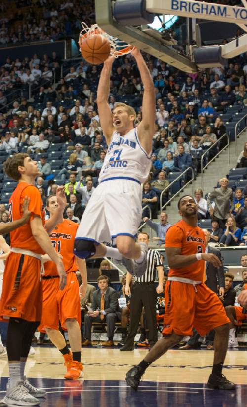 Rick Egan  |  The Salt Lake Tribune

Brigham Young Cougars forward Kyle Davis (21) dunks the ball, as Pacific Tiger defenders look on, in WCC basketball action, Brigham Young Cougars vs. The Pacific Tigers, Saturday, February 6, 2016.