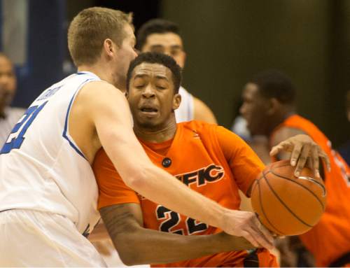 Rick Egan  |  The Salt Lake Tribune

Pacific Tigers guard Ray Bowles (22) is stopped by Brigham Young Cougars forward Kyle Davis (21), in WCC basketball action, Brigham Young Cougars vs. The Pacific Tigers, Saturday, February 6, 2016.