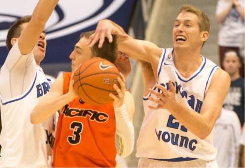 Rick Egan  |  The Salt Lake Tribune

Brigham Young Cougars guard Zac Seljaas (2) and Brigham Young Cougars forward Kyle Davis (21) put pressure on Pacific Tigers guard Alec Kobre (3), in WCC basketball action, Brigham Young Cougars vs. The Pacific Tigers, Saturday, February 6, 2016.