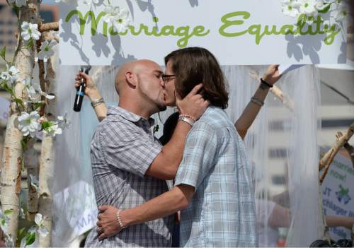 Francisco Kjolseth  |  The Salt Lake Tribune
Darrell Morealle, left, and J.T. Lautenschlager embrace with a kiss after being married on the Overstock float during the Pride Parade, Utah's second-largest parade, after the Days of '47, and by far the most colorful, on Sunday, June 7, 2015 in Salt Lake.