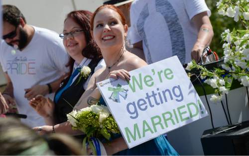Francisco Kjolseth  |  The Salt Lake Tribune
Heather Wright, left, and Brandi Flint wait their turn to be one of three couples married on the Overstock.com float during the Pride Parade, Utah's second-largest parade, after the Days of '47, on the streets of downtown Salt Lake on Sunday, June 7, 2015.