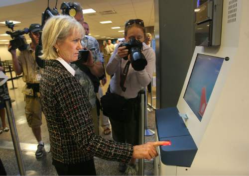Scott Sommerdorf  |  Salt Lake Tribune

News photographers cover Maureen Riley - Executive Director of Salt Lake City Department of Airports - trying out the new Clear Lane terminal now open at SLC Intl Airport, on May 29, 2008.  New "Clear Lane," allows passengers to pay $100 for a quick-access card with federal background check.