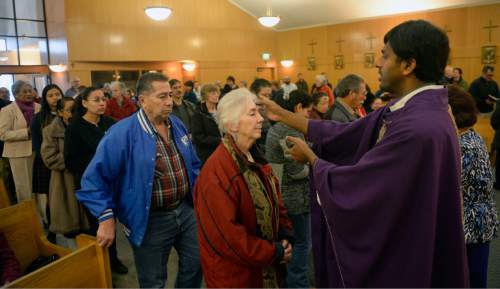 Al Hartmann  |  The Salt Lake Tribune
Father Arokia Dass makes the sign of the cross on foreheads of parishioners during service at Saints Peter and Paul Catholic Church in West Valley City on Ash Wednesday, Feb. 10 marking the start of Lent.