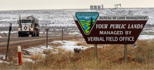 Trent Nelson  |  The Salt Lake Tribune
A BLM sign competes with oil wells for attention along the Nine Mile Canyon National Backcountry Byway in Duchesne County, Tuesday January 19, 2016.