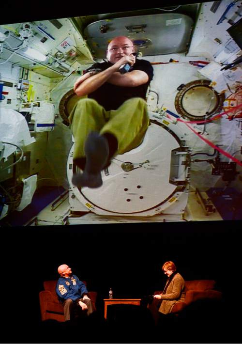 Scott Sommerdorf   |  The Salt Lake Tribune
Retired astronaut and U.S. Navy Captain Mark Kelly, below, looks up at his twin brother, astronaut Scott Kelly, as he answers a question from the International Space Station, during the Natural History Museum of Utah's  annual lecture series "Unraveling The Unknown" at Kingsbury Hall, Wednesday, Feb. 10, 2016.