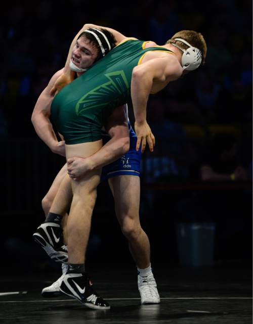 Francisco Kjolseth | The Salt Lake Tribune
Koy Wilkinson of Pleasant Grove, left, battles Ben Bolingbroke of Clearfield in the 5A 170 weight division in the wrestling state championship at Utah Valley University. Wilkinson won by major decision.