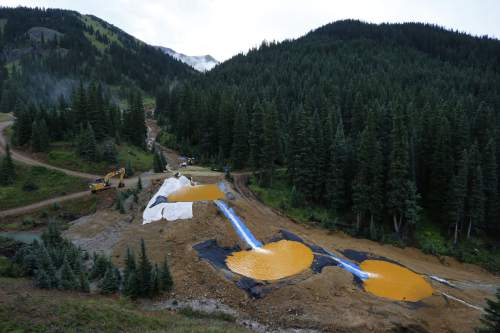 FILE - In this Aug. 12, 2015 file photo, water flows through a series of retention ponds built to contain and filter out heavy metals and chemicals from the Gold King mine chemical accident, in the spillway about 1/4 mile downstream from the mine, outside Silverton, Colo. A U.S. House probe of the mine waste accident in Colorado that fouled rivers in three states with arsenic, lead and other toxic substances has found further evidence that EPA workers knew a spill from the gold mine was possible, according to documents released Thursday, Feb. 11, 2016 by a U.S. House committee.  (AP Photo/Brennan Linsley, file)