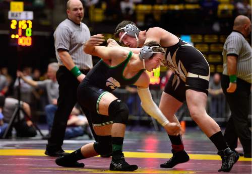 Scott Sommerdorf   |  The Salt Lake Tribune
Ty Meacham of Emery and James Skow of South Summit, foreground, compete in the 220 lb 2A match during the state wrestling tournament at UVU, Friday, February 12, 2016. Meacham pulled off a come-from-behind win after the match had to be delayed to deal with his bloodied nose.