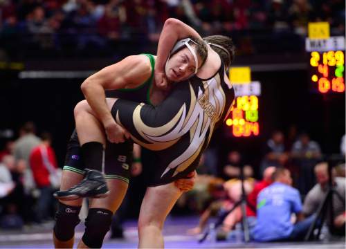 Scott Sommerdorf   |  The Salt Lake Tribune
James Skow of South Summit, left, tries to put Ty Meacham of Emery, on the mat as they compete in the 220 lb 2A match during the state wrestling tournament at UVU, Friday, February 12, 2016. Meacham pulled off a come-from-behind win after the match had to be delayed to deal with his bloodied nose.