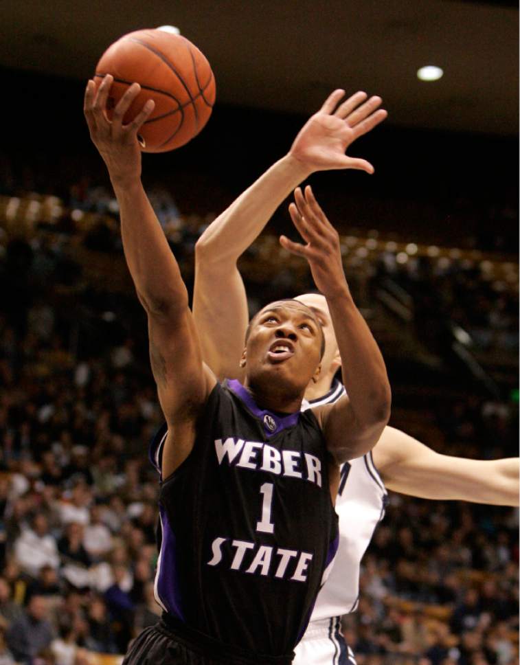 Jim Urquhart  |  The Salt Lake Tribune
Weber's Damian Lillard (1) drives past BYU's Jonathan Tavernari (24) during men's college basketball action Friday, November 27 2009 at the Marriott Center on the campus of Brigham Young University in Provo. BYU hosted Weber State. 11/27/09
