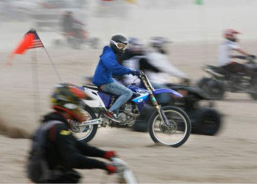 Scott Sommerdorf  |  Salt Lake Tribune
LITTLE SAHARA
A rider blurs past others waiting their turn to power up "Sand Mountain" at Little Sahara National Recreation Area, Saturday 4/3/10. Four- and two-wheel enthusiasts, dune buggies and more kick off the spring season with motorized recreation and camping at Little Sahara sand dunes., Saturday 4/3/10.