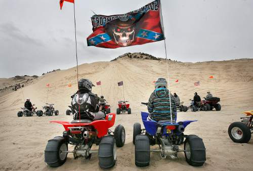 Scott Sommerdorf  |  Salt Lake Tribune
LITTLE SAHARA
A pair of atv riders with paddle tires wait for the impulse to race up "Sand Mountain" at Little Sahara National Recreation Area, Saturday 4/3/10. Four- and two-wheel enthusiasts, dune buggies and more kick off the spring season with motorized recreation and camping at Little Sahara sand dunes.