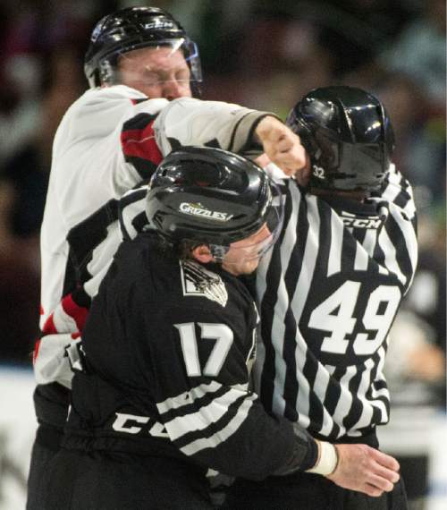 Rick Egan  |  The Salt Lake Tribune

Linesman Official, Andrew Collins, gets caught in the middle, as James Melindy (42), Rapid City Rush fights Utah Grizzlie, T.J. Syner (17) in hockey action Utah Grizzlies vs. The Rapid City Rush, Monday, February 15, 2016.