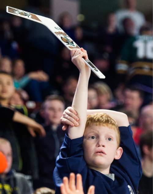 Rick Egan  |  The Salt Lake Tribune

Cash Mower 9, holds his hockey stick high in the air, hoping to get the attention of man shooting T-shirts into the crowd, at the Grizzlies game, Monday, February 15, 2016. The Grizzlies drew a huge crowd in their afternoon holiday game today.