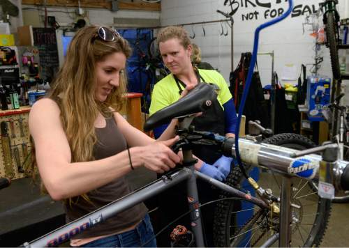 Al Hartmann  |  The Salt Lake Tribune
Volunteer Rachel Hinze, left, works on reconditioning a donated bike during Women's Only night at Salt Lake Bicycle Collective.  Mollie Bourdos, a junior mechanic is there to help or answer questions.  Women's Only night runs from 5:30 -9:00 pm on Wednesday nights where women can work on their own projects or recondition used bicycles.   The Salt Lake Bicycle Collective is at 2312 S. West Temple. The collective's mission is to promote cycling as sustainable transportation.  It provides refurbished bicycles for the community, especially for children and lower income households.