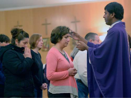 Al Hartmann  |  The Salt Lake Tribune
Father Arokia Dass makes the sign of the cross on foreheads of parishioners during service at Saints Peter and Paul Catholic Church in West Valley City on Ash Wednesday, Feb. 10 marking the start of Lent.