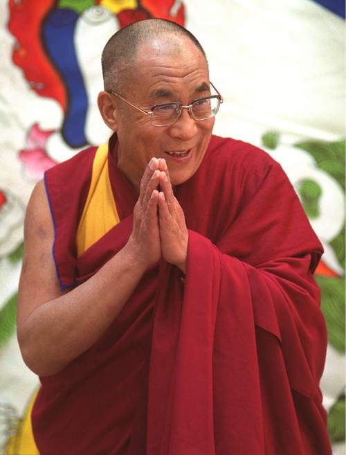 Rick Egan  |  Tribune file photo
His Holiness the Dalai Lama bows to the crowd that greeted him at the airport as he arrived into Salt Lake City in 2001.