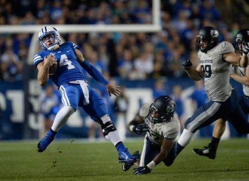 Scott Sommerdorf  |  The Salt Lake Tribune
BYU QB Taysom Hill runs and eludes Utah State Aggies safety Brian Suite (21) during first half play. He later would run a similar play and be injured on a tackle by Suite. Utah State led BYU 28-14 at the half in Provo, Friday, October 1, 2014.