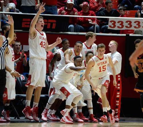 Scott Sommerdorf   |  The Salt Lake Tribune
The Utah bench erupts as they celebrate a 3-point shot by little-used Utah Utes guard Austin Eastman (15) as he got some playing time late in the rout. Utah defeated the USC Trojans 79-55, Friday, January 2, 2015.