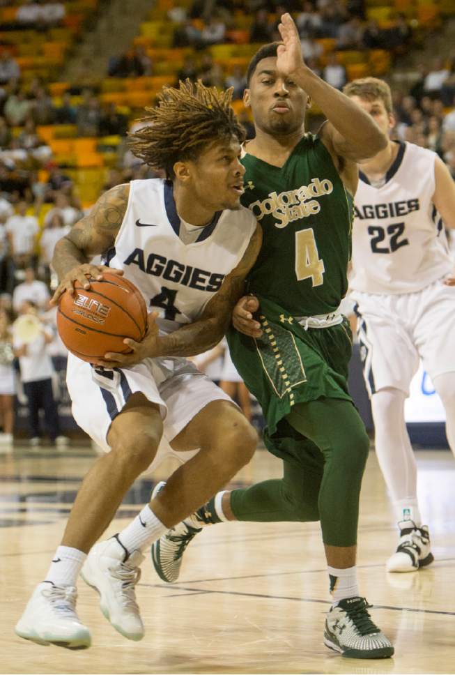 Rick Egan  |  The Salt Lake Tribune

Colorado State Rams guard John Gillon (4) tries to slow down Utah State Aggies guard Shane Rector (4), as he takes the ball inside, in college basketball action, Utah State Aggies vs. The Colorado State Rams, at the Dee Glen Smith Spectrum in Logan,  Wednesday, February 17, 2016.