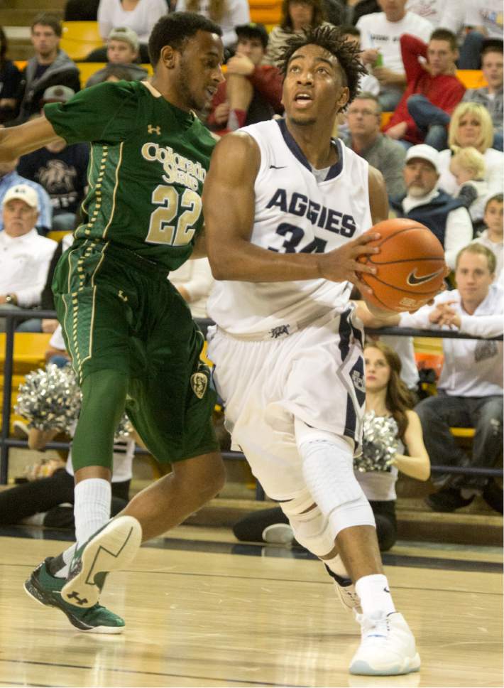 Rick Egan  |  The Salt Lake Tribune

Utah State Aggies guard Chris Smith (34) takes the ball inside, as Colorado State guard Jeremiah Paige (22) defends for the Rams, in college basketball action, Utah State Aggies vs. The Colorado State Rams, at the Dee Glen Smith Spectrum in Logan,  Wednesday, February 17, 2016.