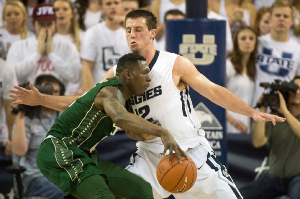 Rick Egan  |  The Salt Lake Tribune

Colorado State Rams forward Emmanuel Omogbo (2) takes the ball inside, as Utah State forward Lew Evans (12) defends for the Aggies, in college basketball action, Utah State Aggies vs. The Colorado State Rams, at the Dee Glen Smith Spectrum in Logan,  Wednesday, February 17, 2016.