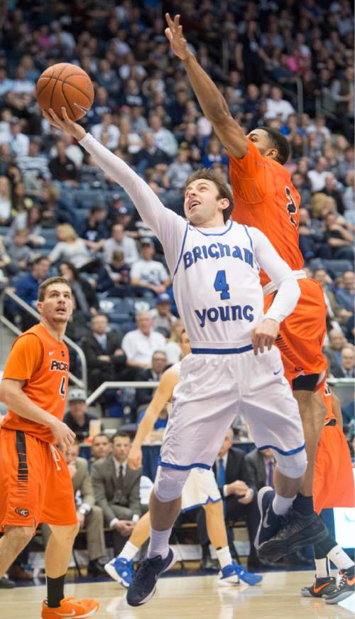 Rick Egan  |  The Salt Lake Tribune

Brigham Young Cougars guard Nick Emery (4) gets by Pacific Tigers guard Ray Bowles (22) as he goes to the hoop, in WCC basketball action, Brigham Young Cougars vs. The Pacific Tigers, Saturday, February 6, 2016.