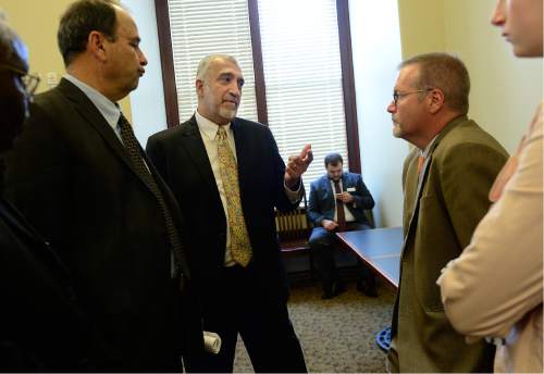 Scott Sommerdorf   |  The Salt Lake Tribune
Sim Gill, District Attorney of Salt Lake County, center, speaks to Senator Stephen Urquhart, R-St. George, right, about the hate crimes bills (SB107 and SJR13) that he is backing, Wednesday, February 17, 2016.