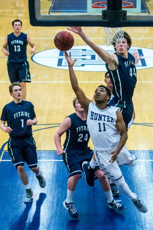 Chris Detrick  |  The Salt Lake Tribune
Syracuse's Kalvin Mudrow (44) blocks a shot attempt from Hunter's Jaleel Holdford (11) during the game at Hunter High School Friday February 19, 2016. Syracuse defeated Hunter 57-51.