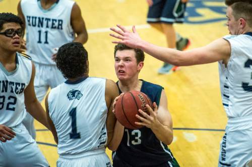 Chris Detrick  |  The Salt Lake Tribune
Syracuse's Drew Carlson (13) is guarded by Hunter's Olson Williams (1) and Hunter's Joseph Arnold (33) during the game at Hunter High School Friday February 19, 2016. Syracuse defeated Hunter 57-51.