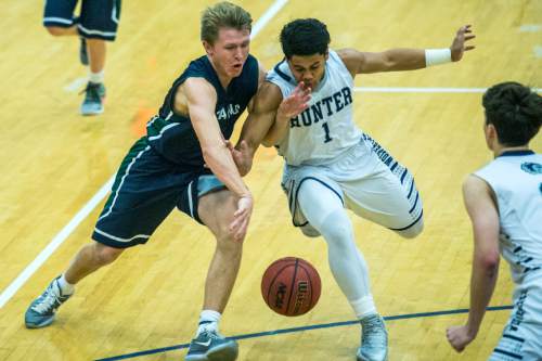 Chris Detrick  |  The Salt Lake Tribune
Syracuse's Braxton Kay (2) and Hunter's Olson Williams (1) go for the ball during the game at Hunter High School Friday February 19, 2016. Syracuse defeated Hunter 57-51.