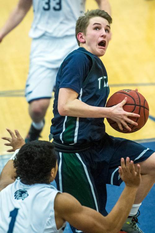 Chris Detrick  |  The Salt Lake Tribune
Hunter's Olson Williams (1) fouls Syracuse's Brock Gilbert (1) during the game at Hunter High School Friday February 19, 2016. Syracuse defeated Hunter 57-51.