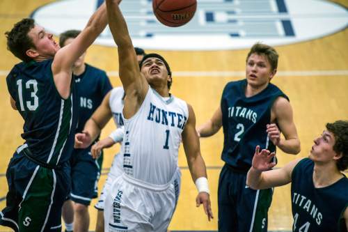 Chris Detrick  |  The Salt Lake Tribune
Syracuse's Drew Carlson (13) blocks Hunter's Olson Williams (1) during the game at Hunter High School Friday February 19, 2016. Syracuse defeated Hunter 57-51.