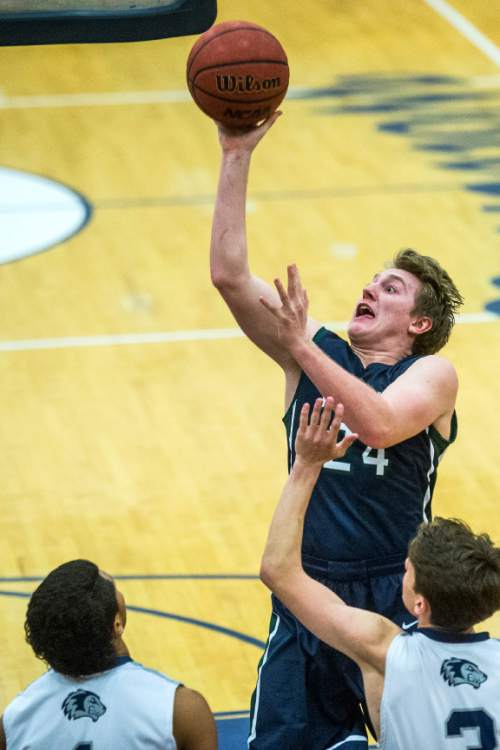 Chris Detrick  |  The Salt Lake Tribune
Syracuse's Haydn Sessions (24) shoots over Hunter's Olson Williams (1) and Hunter's Nathan Rollins (3) during the game at Hunter High School Friday February 19, 2016. Syracuse defeated Hunter 57-51.