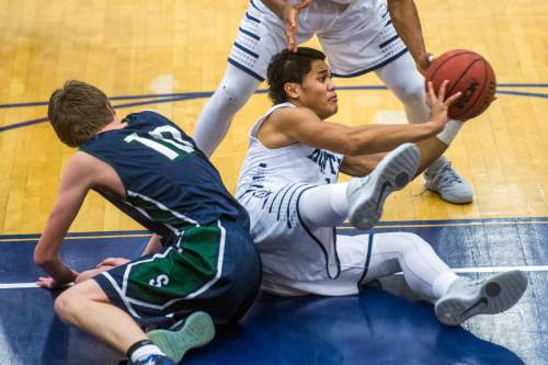 Chris Detrick  |  The Salt Lake Tribune
Hunter's Olson Williams (1) passes around Syracuse's Dylan Brower (10) during the game at Hunter High School Friday February 19, 2016. Syracuse defeated Hunter 57-51.