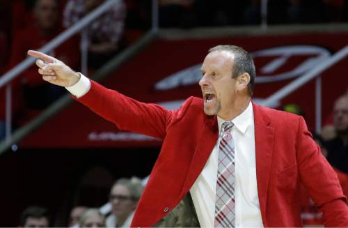 Utah head coach Larry Krystkowiak shouts to his team in the second half during an NCAA college basketball game against BYU Wednesday, Dec. 2, 2015, in Salt Lake City. (AP Photo/Rick Bowmer)