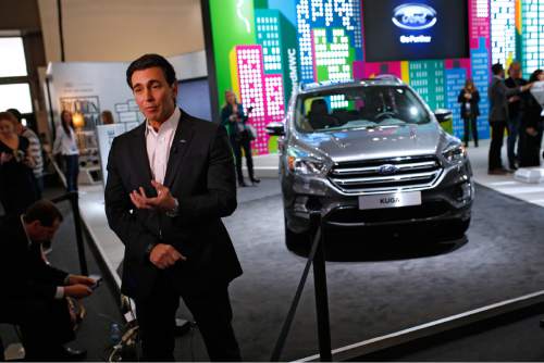 Ford CEO Mark Fields talks during an interview next to the new Kuga SUV car, which features its latest connectivity and driver-assisted technology, during the Mobile World Congress Wireless show, the world's largest mobile phone trade show, in Barcelona, Spain, Monday, Feb. 22, 2016. (AP Photo/Francisco Seco)