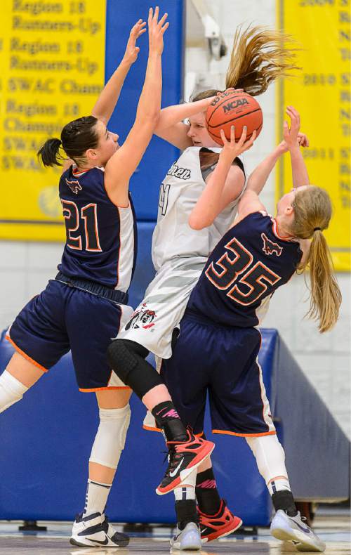 Trent Nelson  |  The Salt Lake Tribune
American Fork's Taylor Franson, defended by Mountain Crest's Olivia Wiberg and Sheridan Jaussi as American Fork faces Mountain Crest in a first round game at the 5A High School Girls Basketball Tournament at Salt Lake Community College in Taylorsville, Tuesday February 23, 2016.
