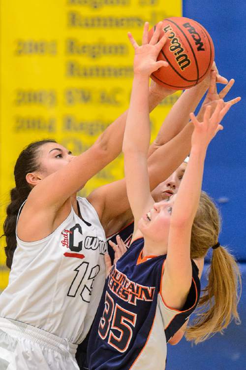 Trent Nelson  |  The Salt Lake Tribune
American Fork's Taylor Moeaki and Mountain Crest's Sheridan Jaussi reach for the ball as American Fork faces Mountain Crest in a first round game at the 5A High School Girls Basketball Tournament at Salt Lake Community College in Taylorsville, Tuesday February 23, 2016.