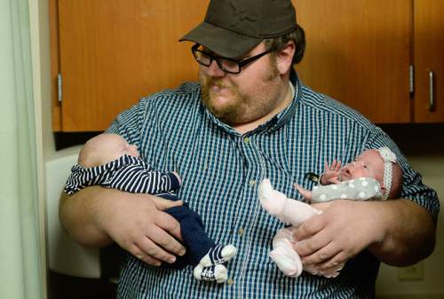 Francisco Kjolseth | The Salt Lake Tribune
Dustin Wall holds his newborn twins Kyler and Kenadee at Timpanogos Regional Hospital on Monday. Identical twin sisters Kerri Bunker and Kelli Wall, became pregnant around the same time. Fast forward to the last three weeks, and they each delivered their second set of twins at the same hospital.