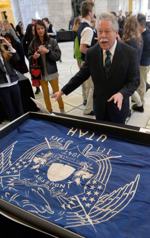 Al Hartmann  |  The Salt Lake Tribune
Senate Minority Leader Gene Davis looks at the first Utah state flag created in 1903 by the request of Governor Heber M. Wells.  The flag was on display along with many exhibits and unusual state items at History Day on the Hill in the Capitol rotunda.